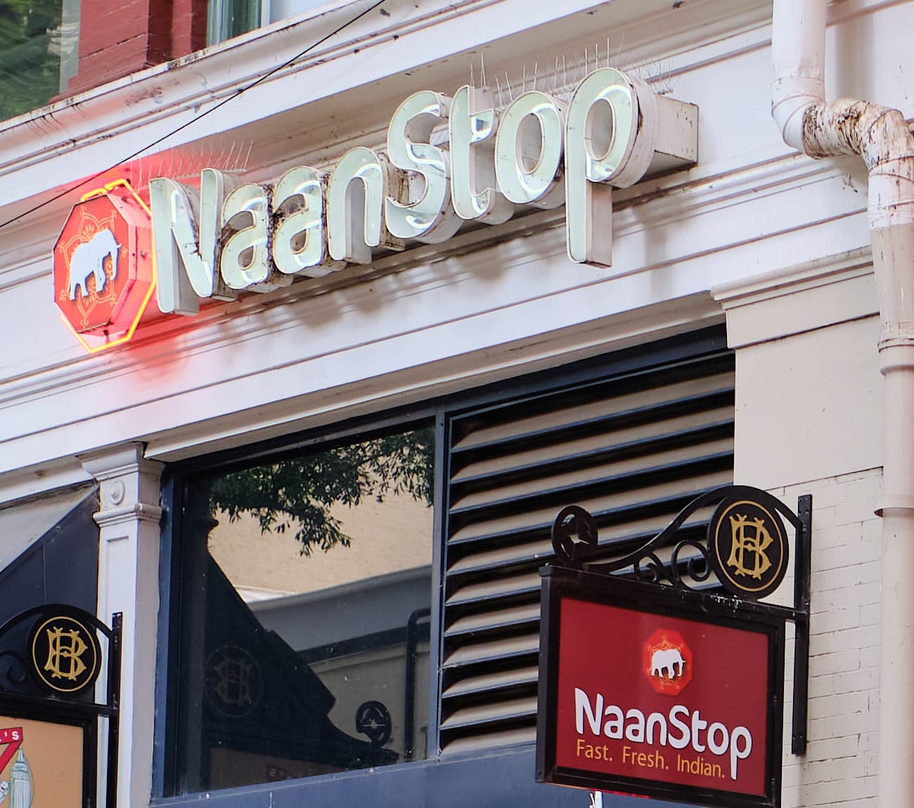 NaanStop's illuminated storefront sign and awning at 64 Broad St NW, Downtown Atlanta