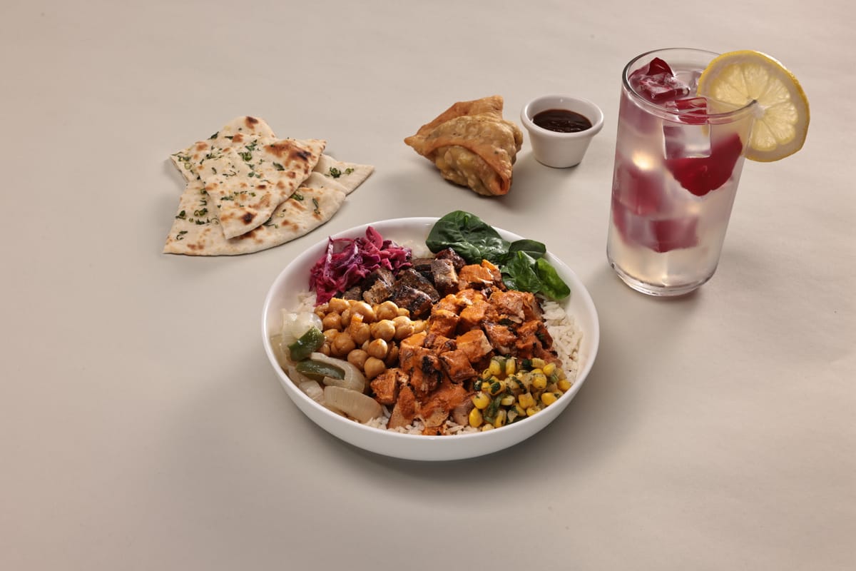 NaanStop food spread with garlic naan, samosa, rosewater lemonade and a rice bowl